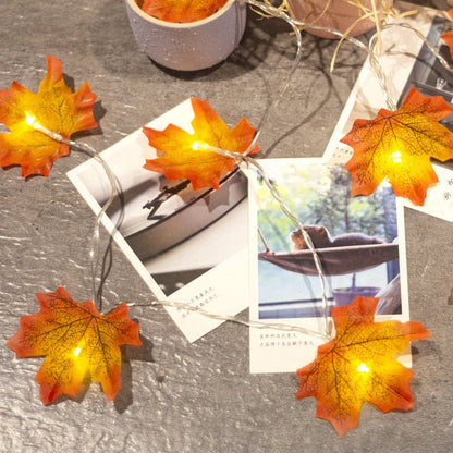 Halloween lights with red orange maple leaf designs