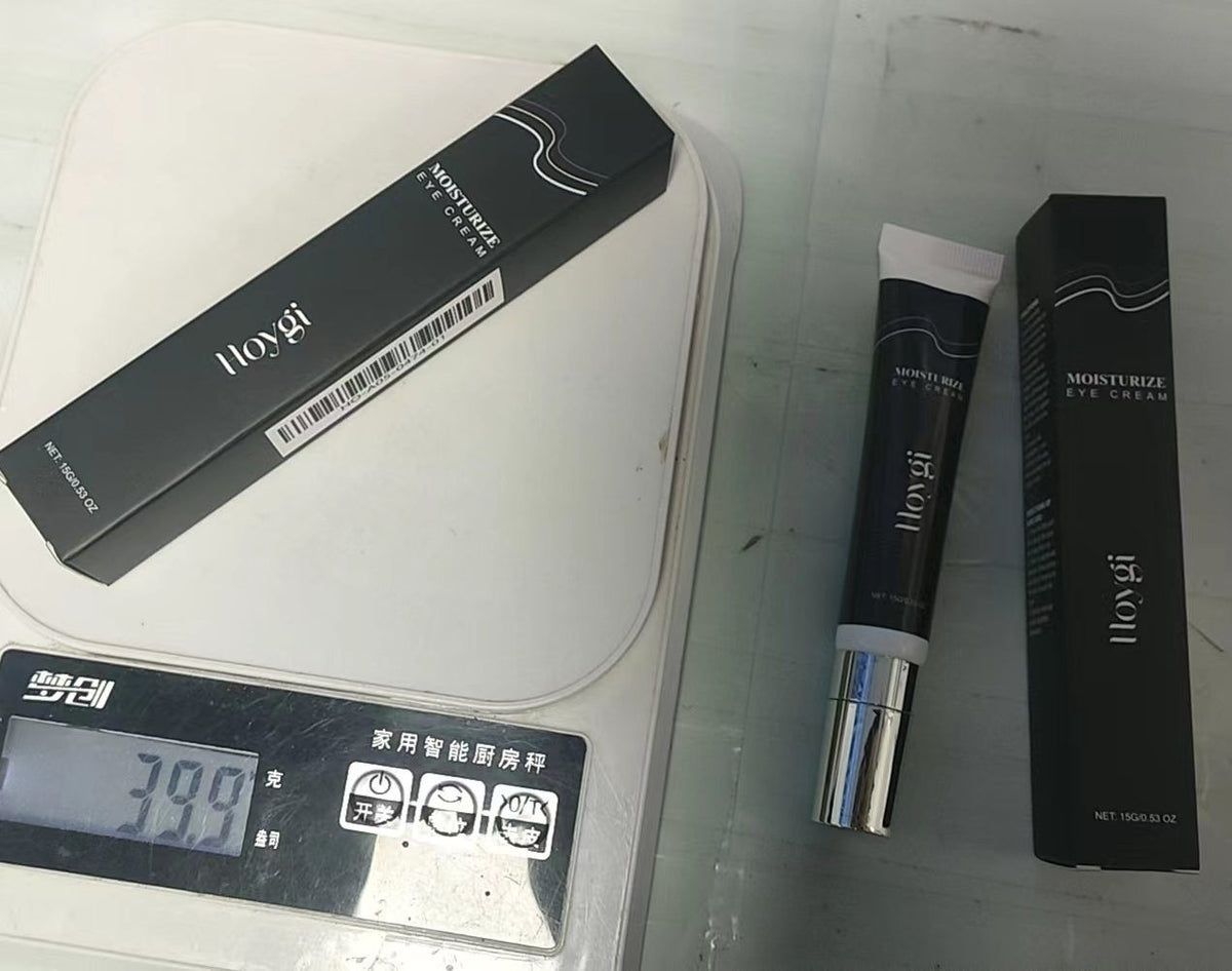 HOYGI eye moisturizer cream 15g tube and box shown on a weighing scale